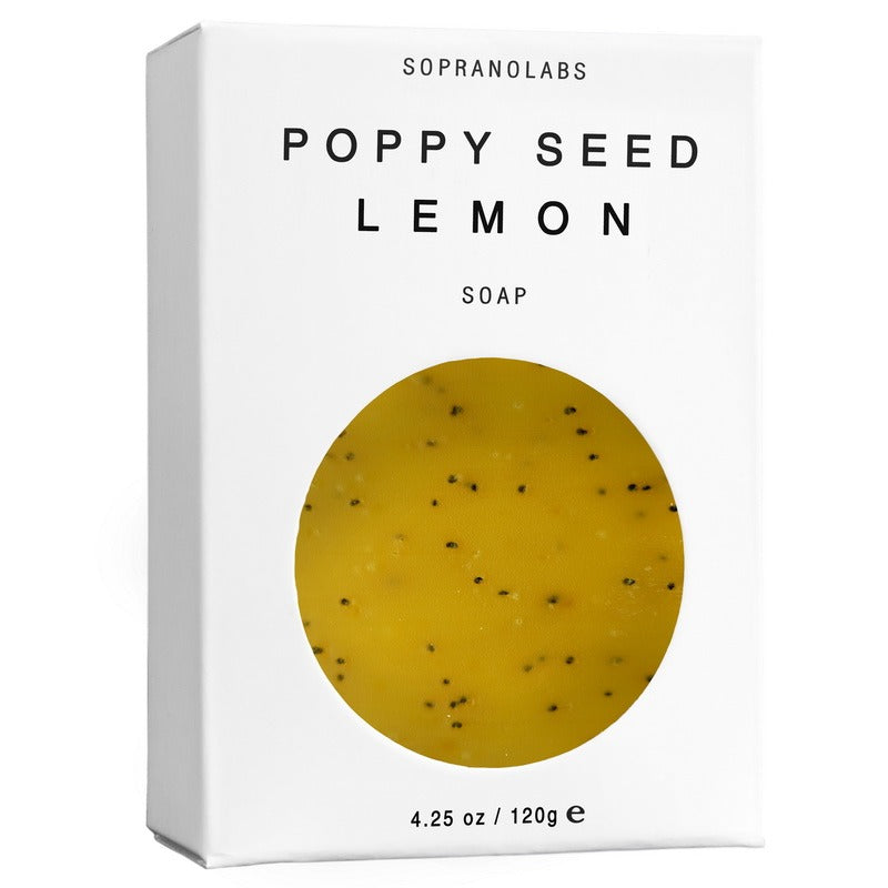 Box of poppy seed lemon soap with a yellow soap bar on a white background