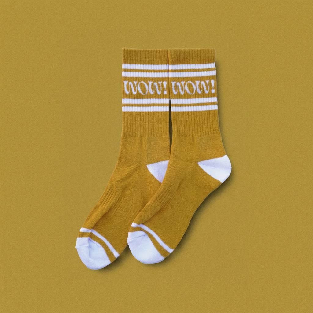 Yellow socks  that say "wow" on them with white stripes and a yellow background.